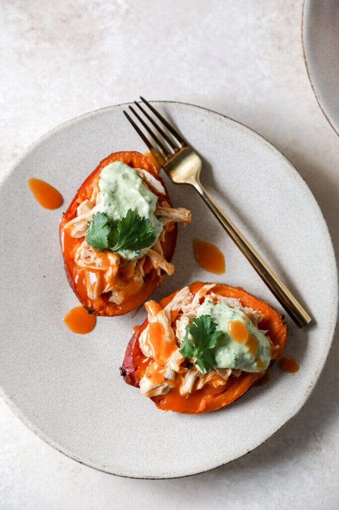 Buffalo Chicken Stuffed Sweet Potatoes with Creamy Avocado Sauce