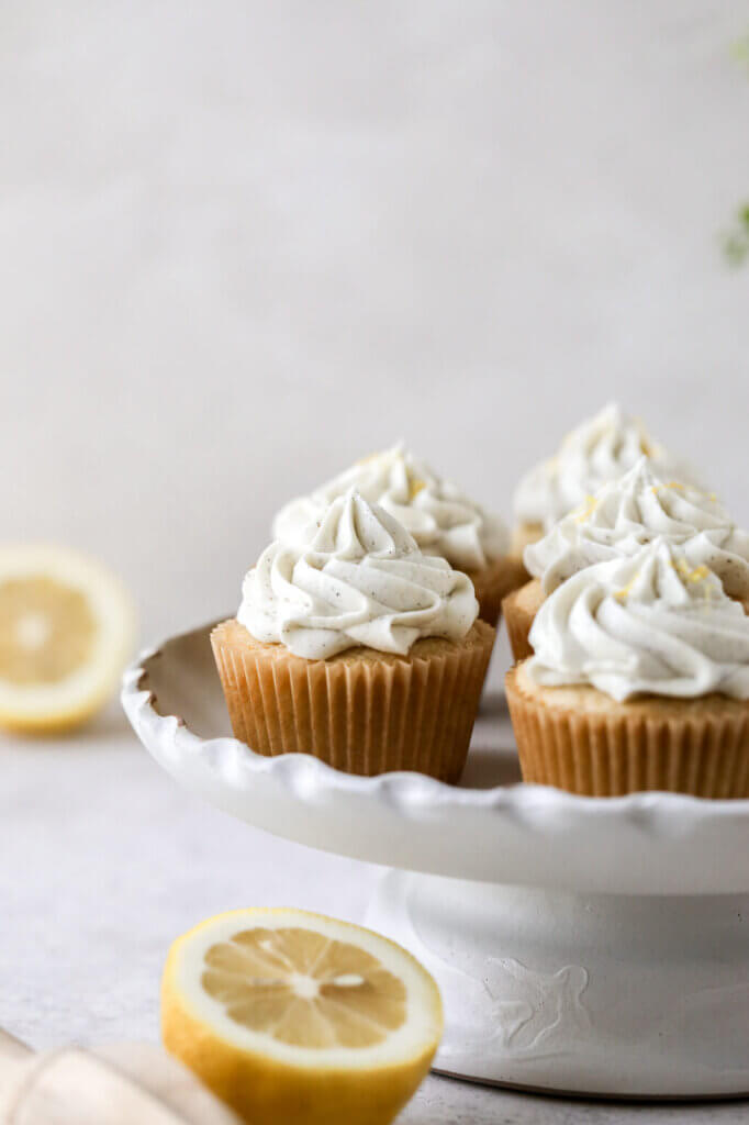 A cake stand with lemon cupcakes and dairy-free buttercream