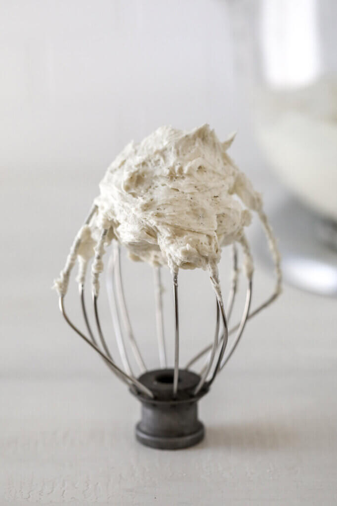 A mixer whisk attachment with dairy-free buttercream.